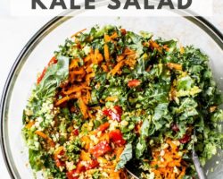 This is an overhead image of a glass bowl with chopped kale and veggies in it. text overlay reads "the best chopped kale salad"