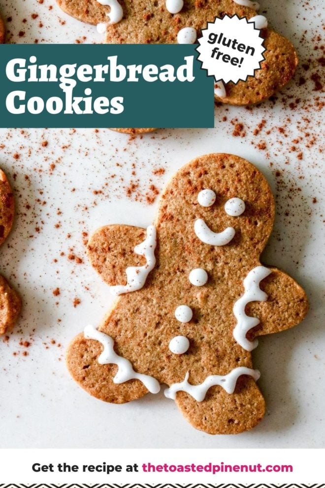 This is an overhead image of gingerbread men cookies with decorative icing. The cookies lay on a white counter and a sprinkle of cinnamon on top. Text overlay reads "gluten free gingerbread cookies."