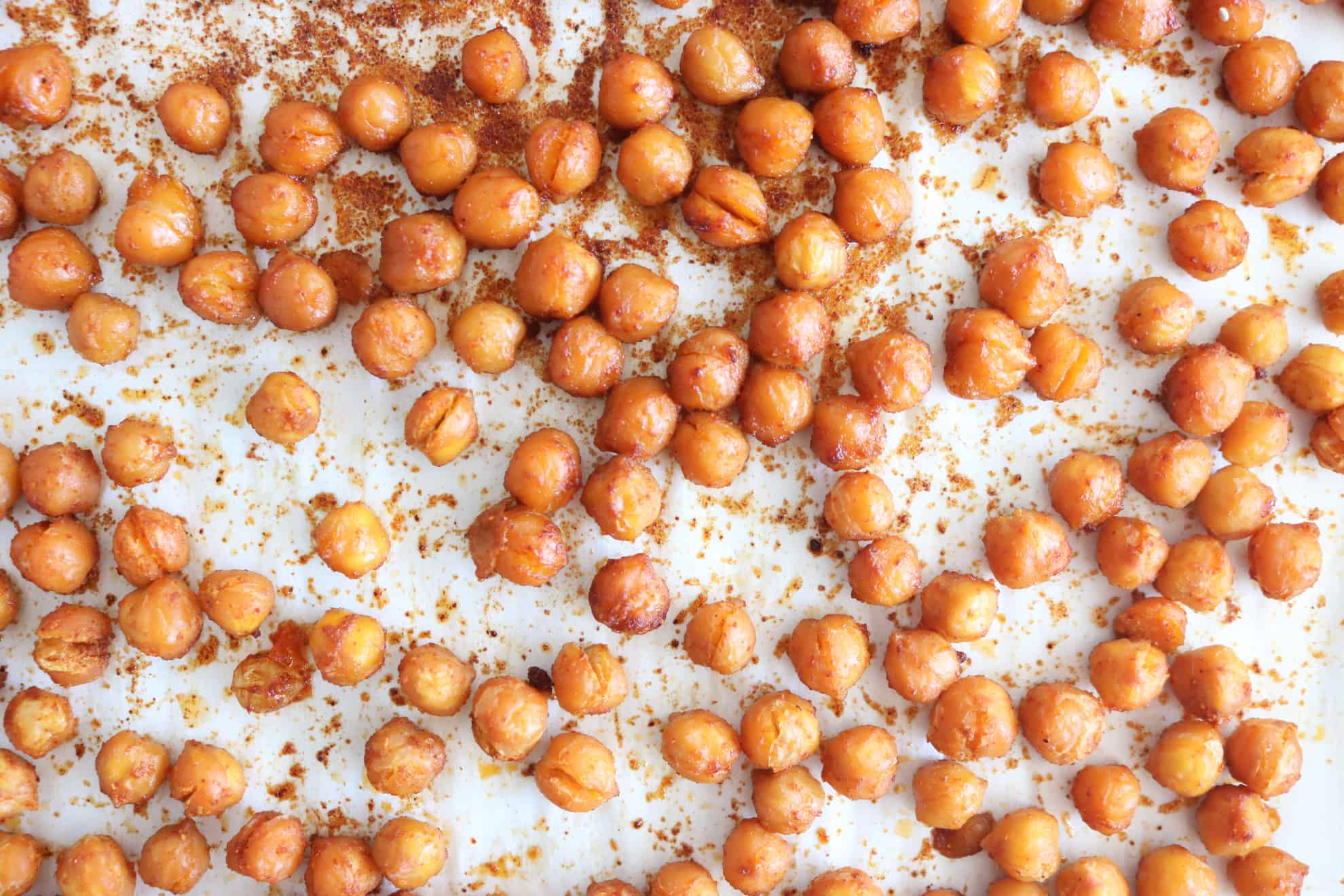Toss the chickpeas with avocado oil paprika, chili powder, and sea salt. Transfer them to a lined baking sheet and roast in the oven for 15 minutes.