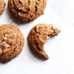overhead image of ginger molasses cookies with a bite taken out