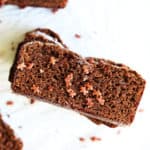 overhead image of a stack of gingerbread slices on a white counter sprinkled with mini gingerbread men sprinkles