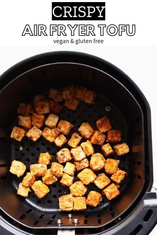 crispy air fryer tofu cubes in ar fryer basket on white background pinterest image