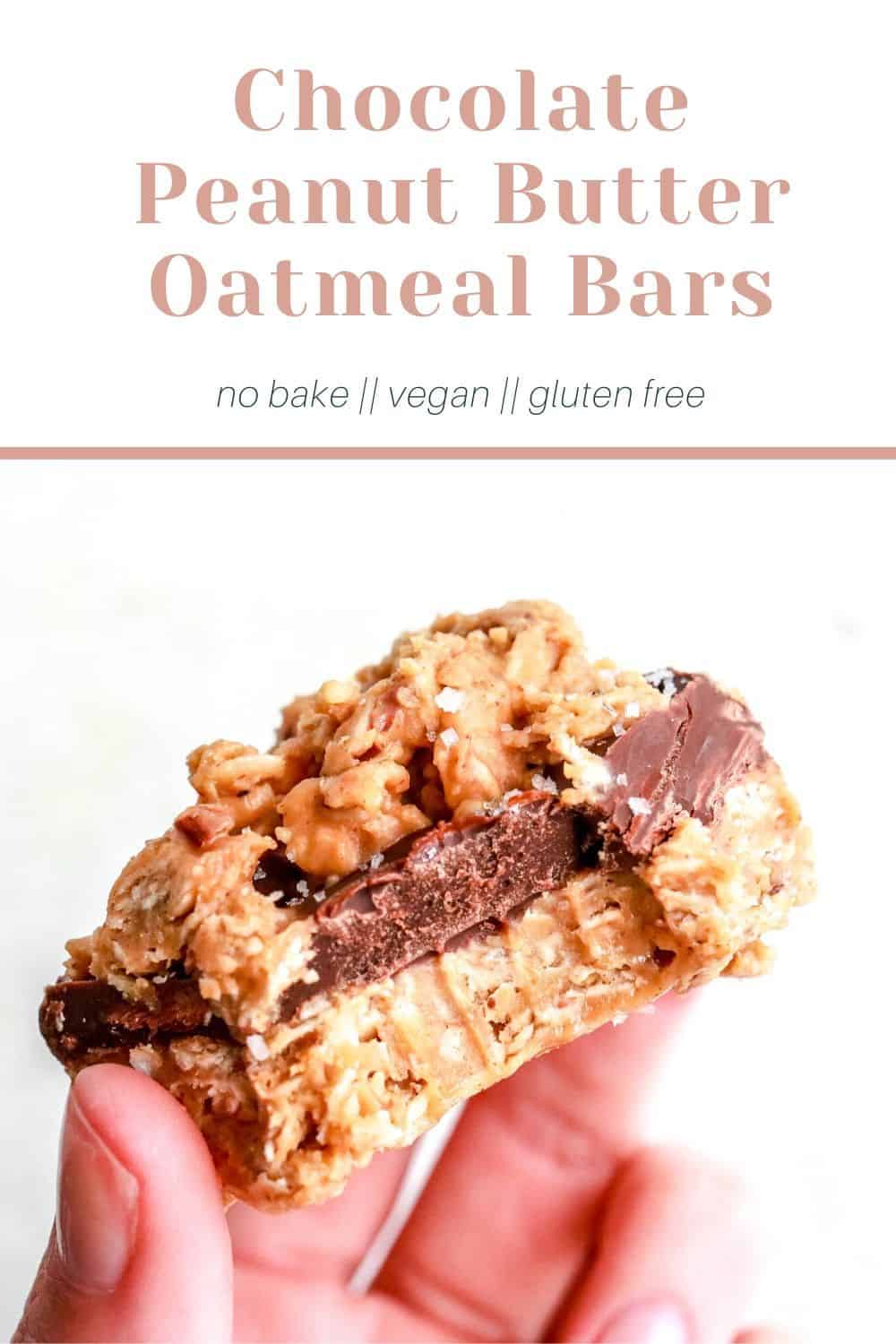 hand holding a chocolate peanut butter oatmeal bar on white background pinterest image