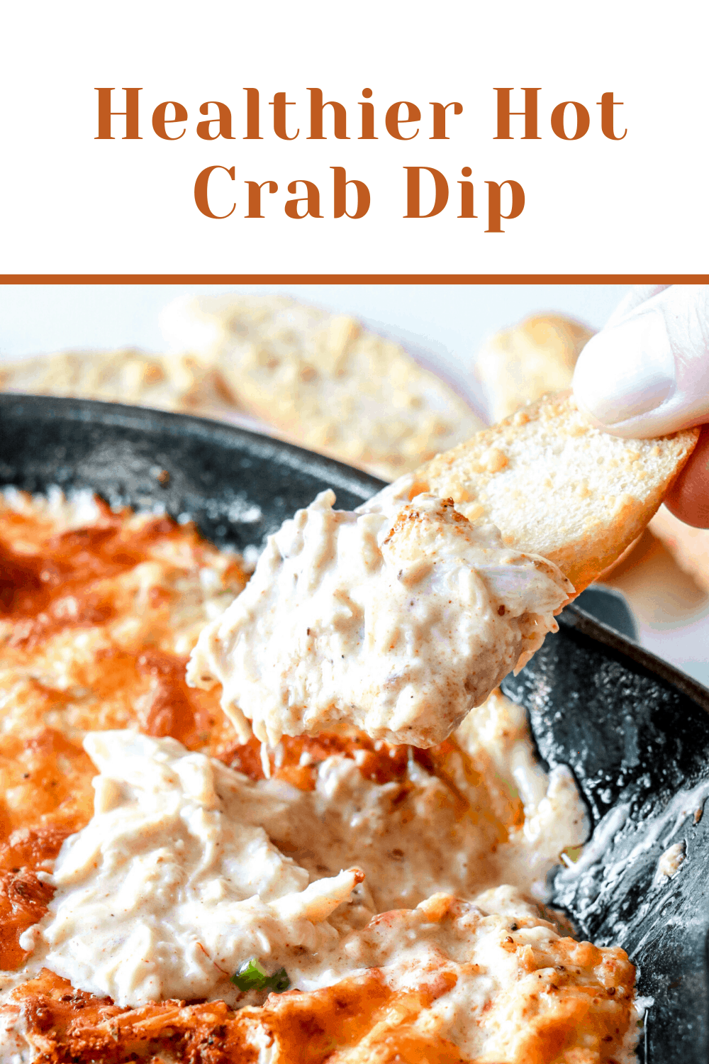side view of hot crab dip with bread dipping into it pinterest image