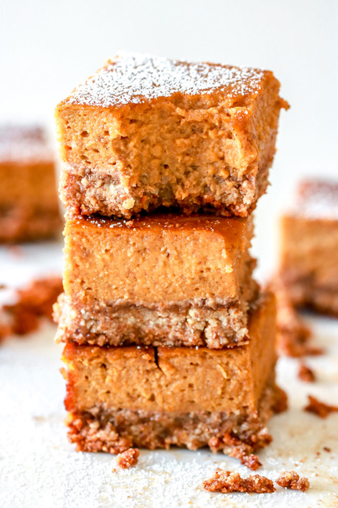 stack of three pumpkin pie squares with powdered sugar sprinkled on top