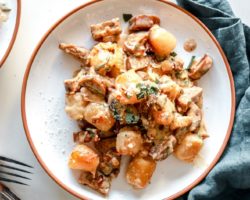 overhead image of a plate with trader joe's gnocchi cooked in a creamy sauce with sausage and caramelized onions