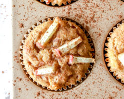 muffins in a muffin tin with apple chunks on top
