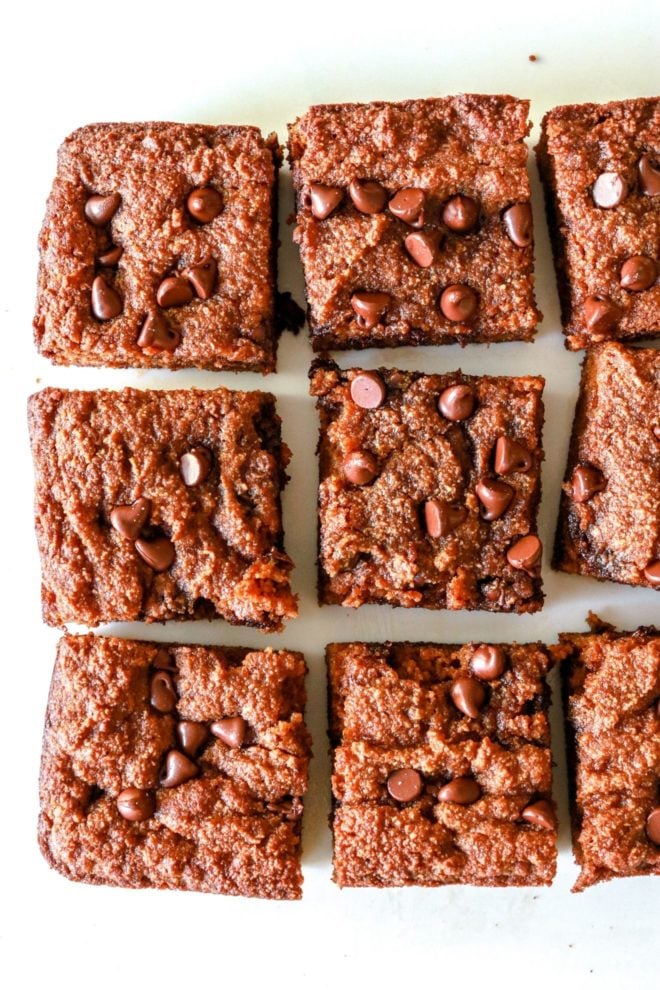 overhead image of chocolate chip pumpkin spice blondies cut in squares on a white background