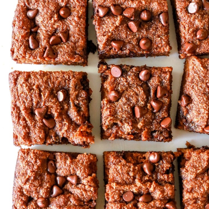 overhead image of chocolate chip pumpkin spice blondies cut in squares on a white background