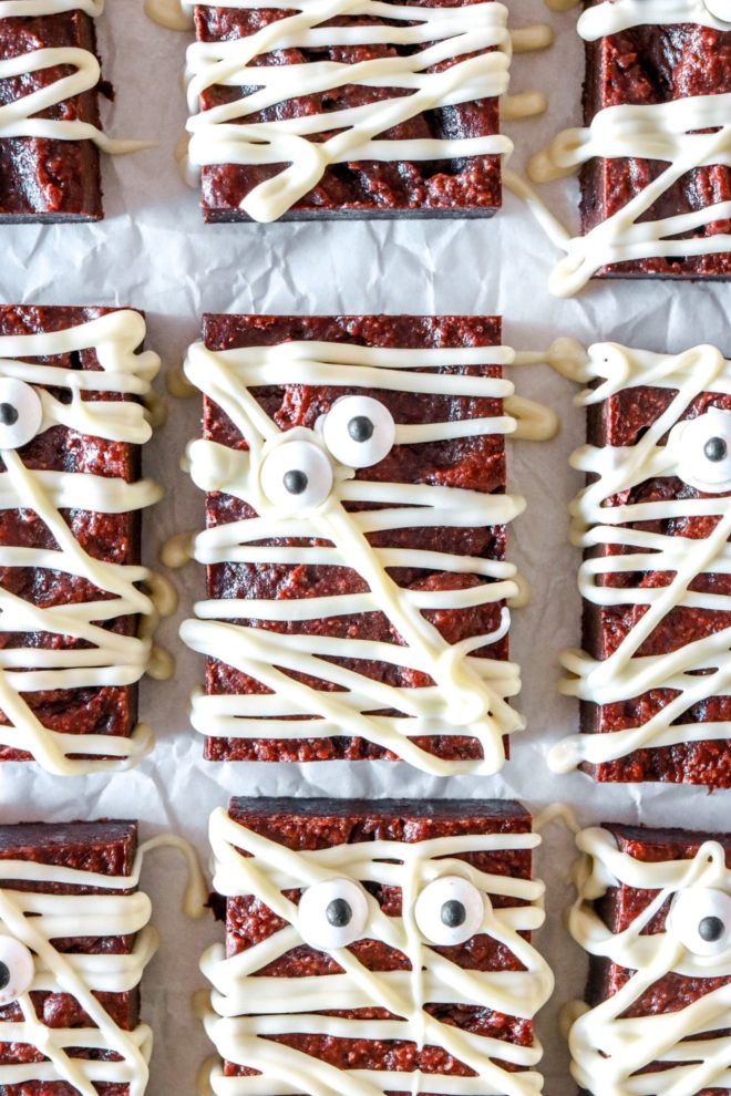gluten free brownies decorated like a mummy using white chocolate and candy eyeballs