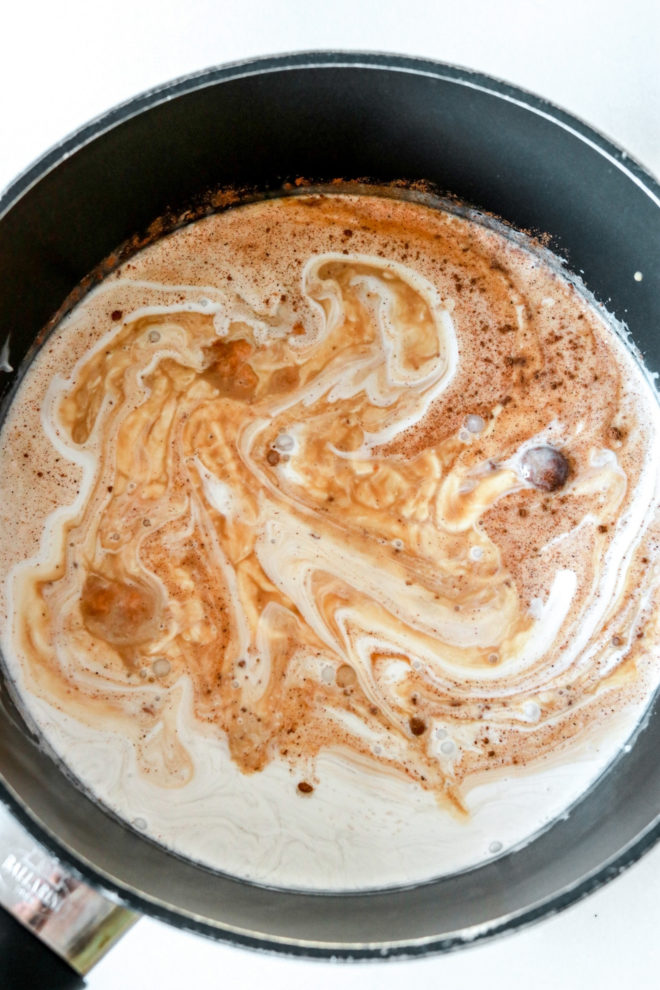 overhead image of a saucepot filled with ingredients to make a pumpkin spice latte