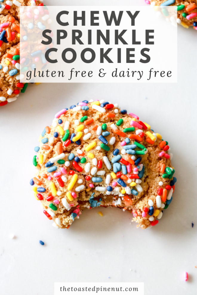overhead view of gluten free sprinkle cookies with rainbow sprinkles with a bite taken out on a white counter, pinterest image with text overlay