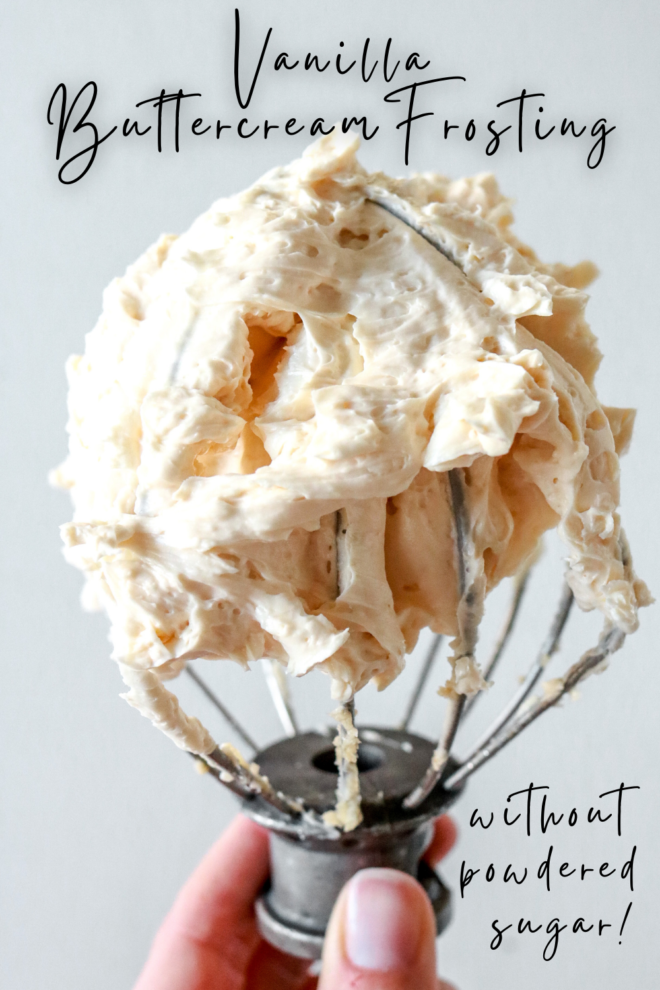 hand holding a standing electric mixer whisk filled with creamy vanilla frosting with text overlay "vanilla buttercream frosting without powdered sugar!"