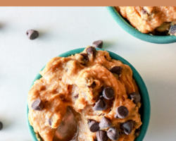 This is an overhead image of a small teal bowl filled with chocolate chip cookie dough. A spoon is scooping a bite of cookie dough and chocolate chips are scattered on the white counter around the bowl. Text overlay reads "chickpea cookie dough vegan & gluten free"
