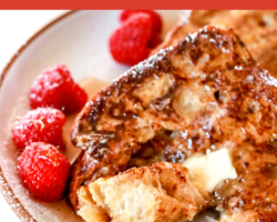 This is a side image of a plate with french toast and raspberries on it. A fork is piercing a bite of french toast and is laying on the side of the plate. Text overlay reads "healthy french toast dairy free & easy to make!"
