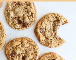 This is an overhead image of chocolate chip cookies laid out on a white surface. One cookie has a bite taken out. Text overlay at the top reads "chewy chocolate chip cookies made with almond flour!"