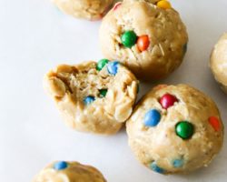 This is an overhead view of peanut butter and oat energy balls with rainbow candies pressed into them.