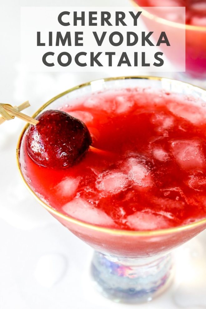This is an overhead image of a martini glass with a cherry cocktail in it. The glass sits on a white counter. A toothpick is piercing a fresh cherry and leaning against the side of the cocktail. Text overlay reads "cherry lime vodka cocktails."