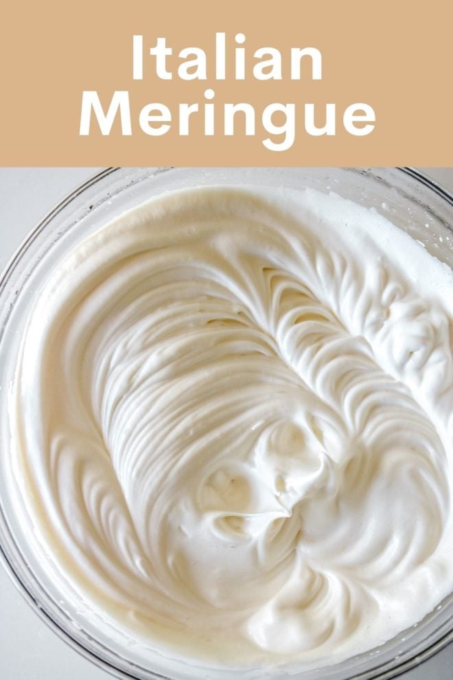 This is an overhead image of a glass bowl on a white surface. Inside the bowl is fluffy white meringue. Text overlay reads "Italian Meringue."