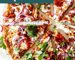 This is an overhead image of a slice of pumpkin pizza topped with red onions, cheese, bbq sauce and cilantro. The slices sit on a white piece of parchment paper. Text overlay reads :bbq jackfruit pumpkin pizza gluten free!"