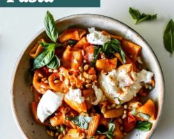 This is an overhead view of a bowl of harissa pasta. The pasta is topped with burrata, pine nuts, and basil. Text overlay reads "harissa pasta only 30 minutes!"