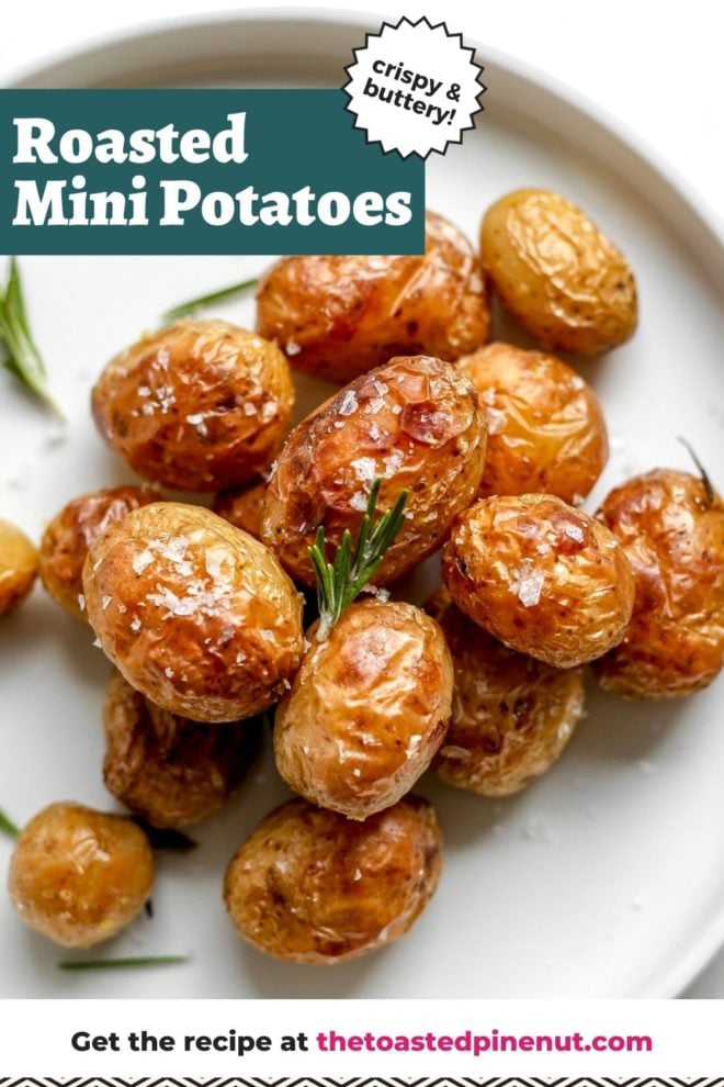 This is an overhead image of a white plate on a light grey counter. One the plate are crispy baby potatoes sprinkled with salt and rosemary sprigs. A small bowl of salt is to the top left corner of the image. Text overlay reads :crispy & buttery roasted mini potatoes."