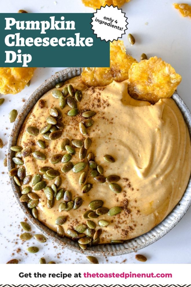 This is an overhead image of a grey shallow bowl with pumpkin cream cheese dip topped with pumpkin seeds and a sprinkle of pumpkin spice. The bowl sits on a white counter with more seeds surrounding it. Two plantain chips are dipping into the dip and more chips are to the top left and right of the image. Text overlay reads "pumpkin cheesecake dip only 4 ingredients."
