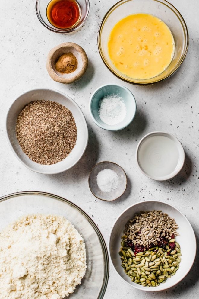 This is an overhead image of ingredients to make flaxseed bread sitting on a white surface.