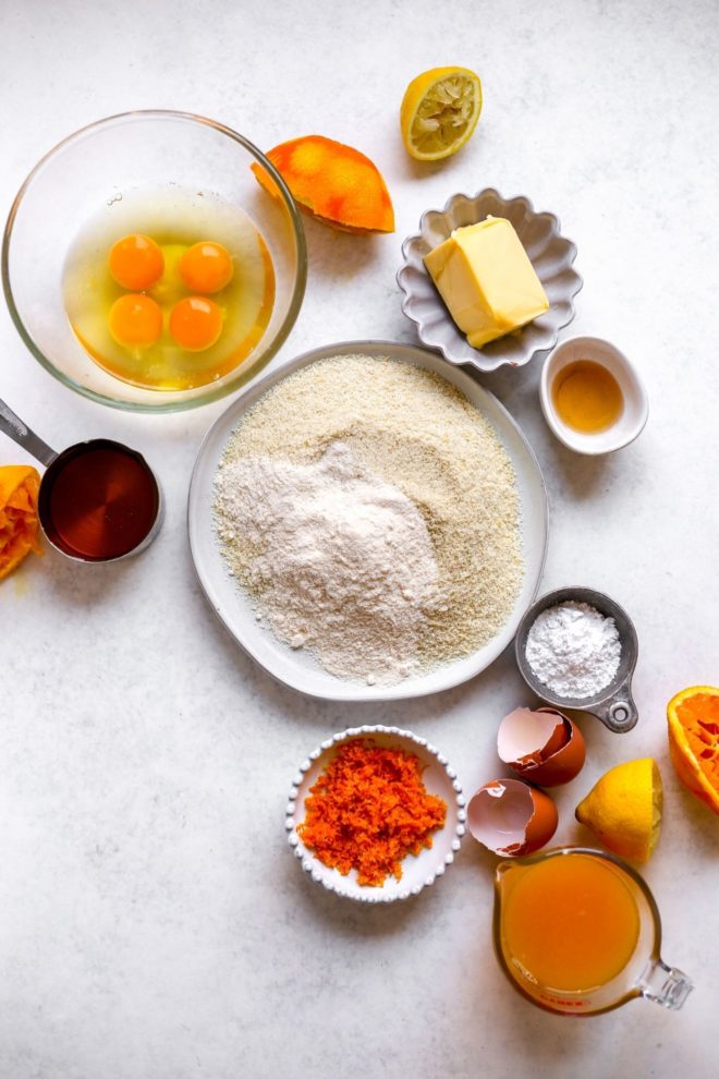 This is an overhead image of all the ingredients to make orange bars won a white surface.