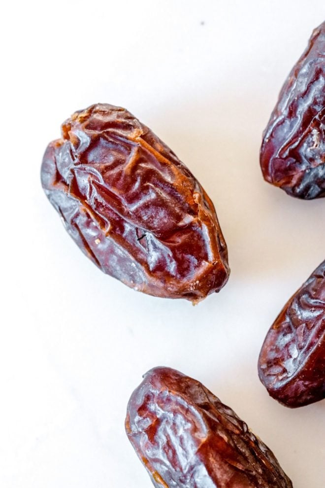 This is an overhead closeup of dates sitting on a white counter.
