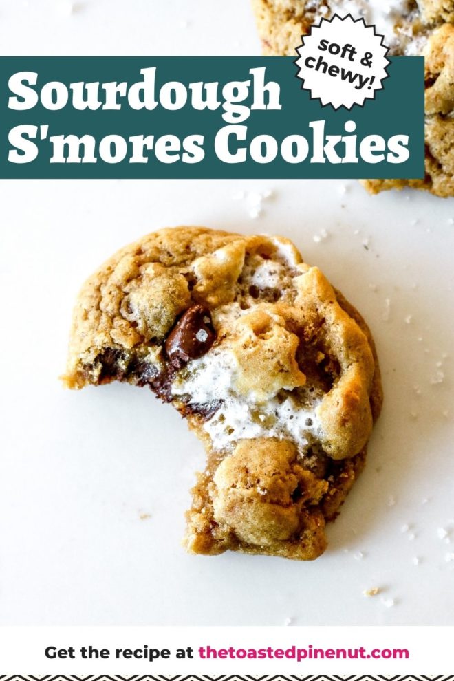 This is an overhead image of a cookie with chocolate chips and marshmallows. The cookie has a bite taken out of it and sits on a white counter with another cookie in the top right and bottom right corner of the image. Text overlay reads "sourdough s'mores cookies soft & chewy"