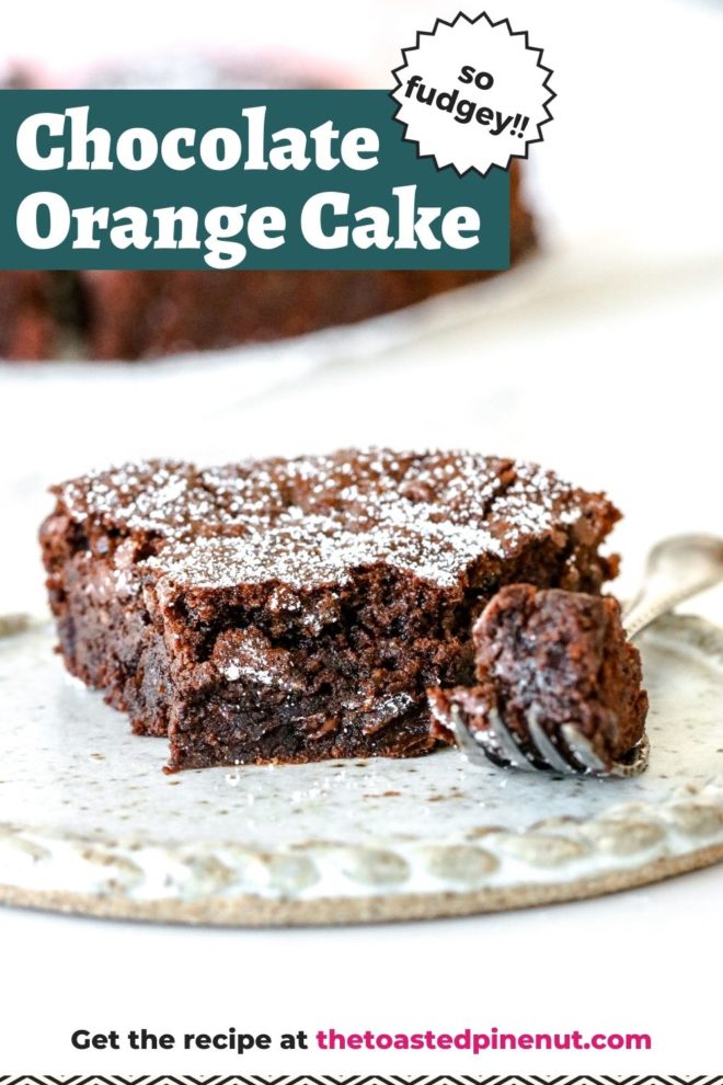 This is a side view of a chocolate cake slice on a plate. The plate is on a white counter and more cake is blurred in the background. A fork has a bite of the cake and is leaning on the side of the plate next to the slice of chocolate cake. Text overlay reads "chocolate orange cake so fudgey!!"