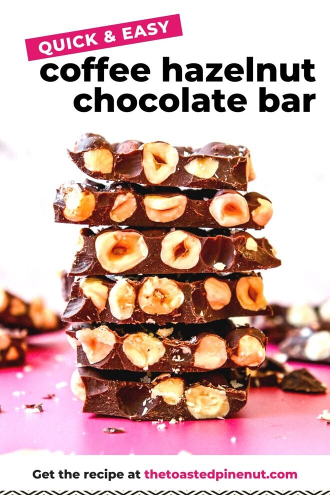 This is a vertical image looking at a stack of chocolate bars from the side. The chocolate has tons of hazelnuts in it. The stack sits on a dark pink counter with more chocolate pieces and crumbs blurred in around the stack and in the background. The stack sits against a white background. Text overlay reads "quick & east coffee hazelnut chocolate bar get the recipe at thetoastedpinenut.com"