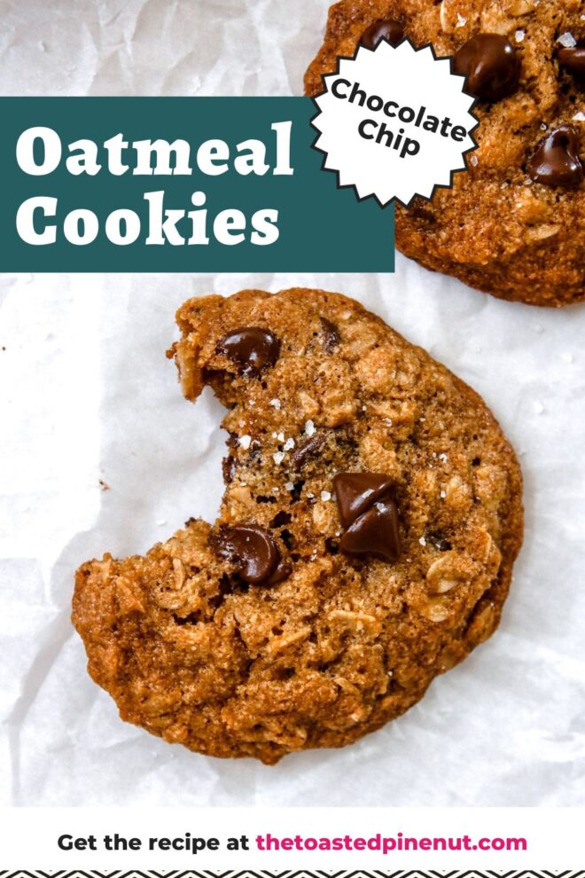 This is an overhead vertical image of an oatmeal chocolate chip cookie with a bite taken out of it. The cookie is sprinkled with flakey salt and sits on a white piece of parchment paper. Another cookie is in the top right corner of the image. Text overlay reads "chocolate chip oatmeal cookies get the recipe at thetoastedpinenut.com"