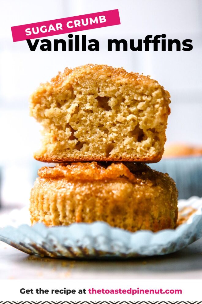 This is a vertical image looking at a stack of two vanilla muffins with a sugary crumb on top. The top muffin is cut in half and both muffins are sitting on a light blue muffin liner. The stack sits on a white surface with a white background and more muffins blurred in the back. Text overlay reads "sugar crumb vanilla muffins."