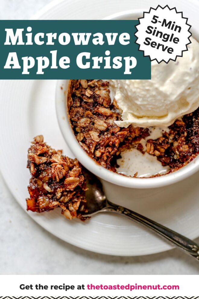 This is an overhead horizontal image of a small white ramekin with a baked apple oat crisp in it. A big scoop of vanilla ice cream is on top of the crisp. The ramekin is on a small white plate. A silver spoon has scooped a bite of the apple crisp out and is lying next to the ramekin on the plate. The plate sits on a light grey surface. Text overlay reads "5-min single serve microwave apple crisp."