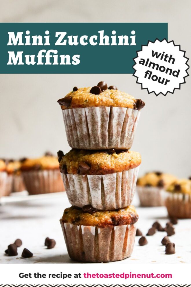 This is a vertical image looking at a stack of three mini muffins from the side. The muffins have white paper liners on them and chocolate chips on top. The stack sits on a white surface with more mini muffins blurred in the background and mini chocolate chips on the surface scattered around the muffins. Text overlay reads "mini zucchini muffins with almond flour."
