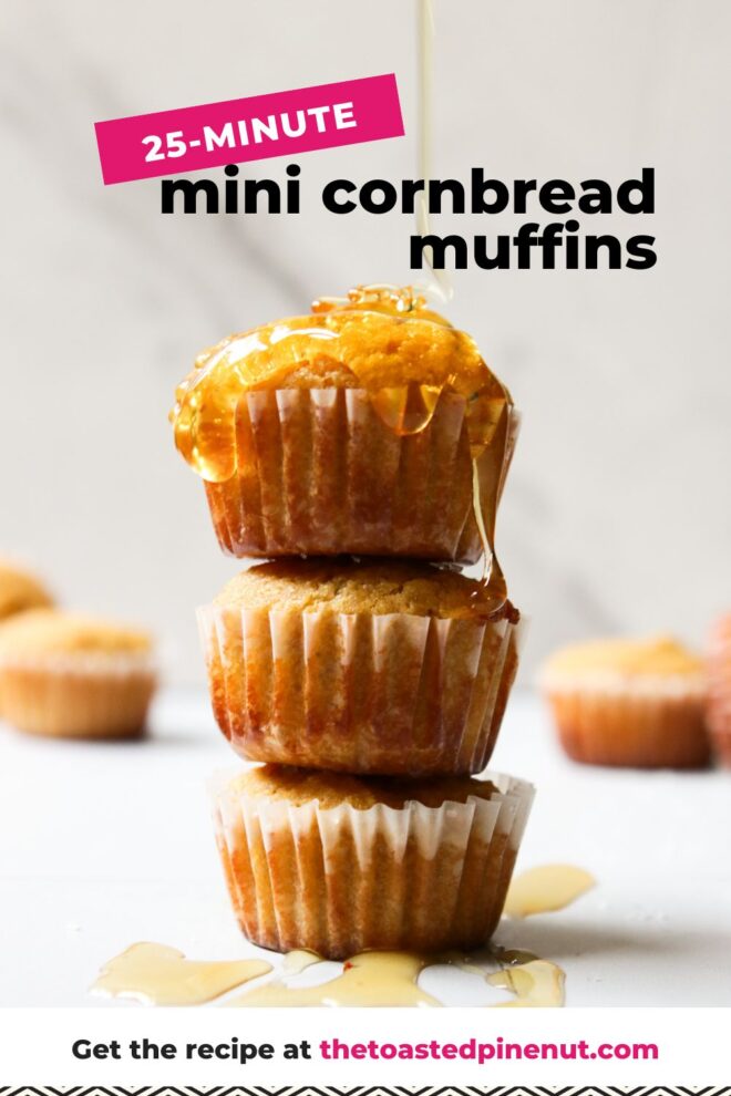 This is a vertical image looking at a stack of three mini muffins from the side. The stack sits on a white surface with more mini muffins are blurred in the background. Honey drizzled on top of the stack with some drips on the white surface around the stack. Text overlay reads "25-minute mini cornbread muffins."
