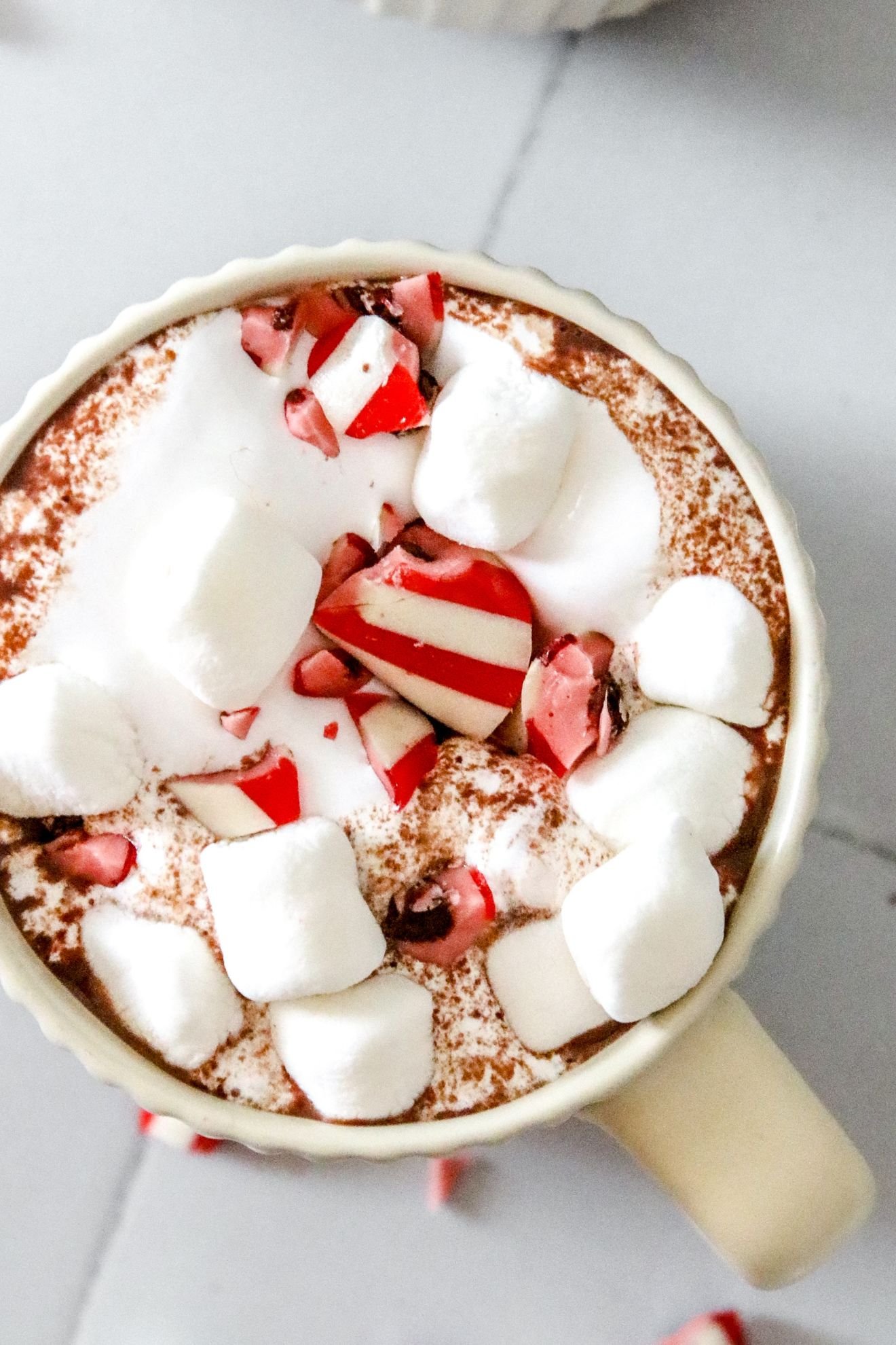 Peppermint hot chocolate with marshmallow and candy cane sweets in