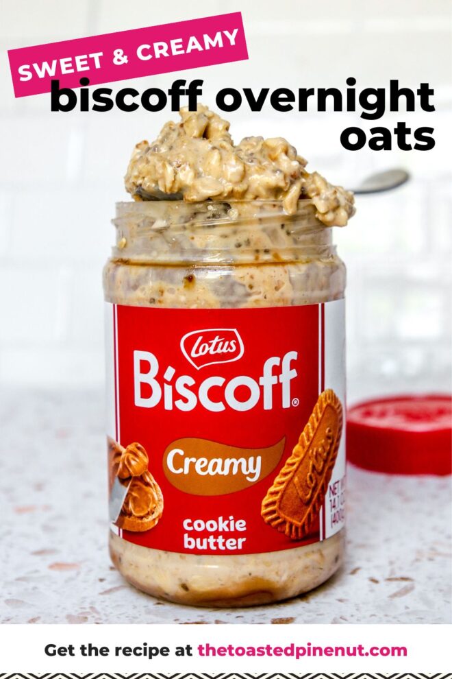 This is a vertical image looking at a labeled biscoff jar filled with overnight oats. A spoon with a heaping spoonful of oats is leaning across the top of the jar. The jar sits on a white terrazzo surface with a white tile background. A red plastic lid is on the surface behind the biscoff jar blurred in the background. Text overlay reads "sweet & creamy biscoff overnight oats".